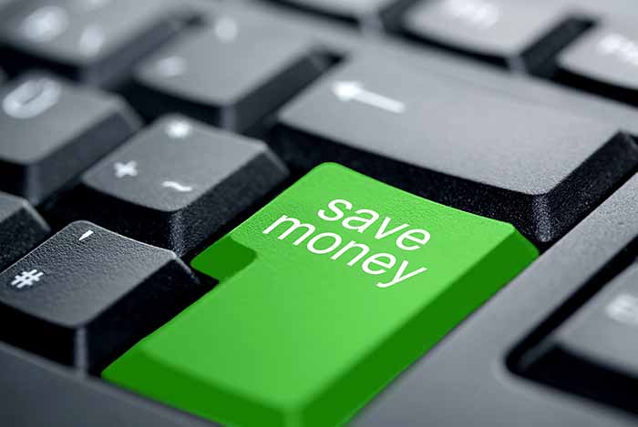Bright green keyboard key labeled 'save money' on black computer keyboard